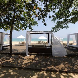 On the beach, white sand, sun-loungers, beach umbrellas