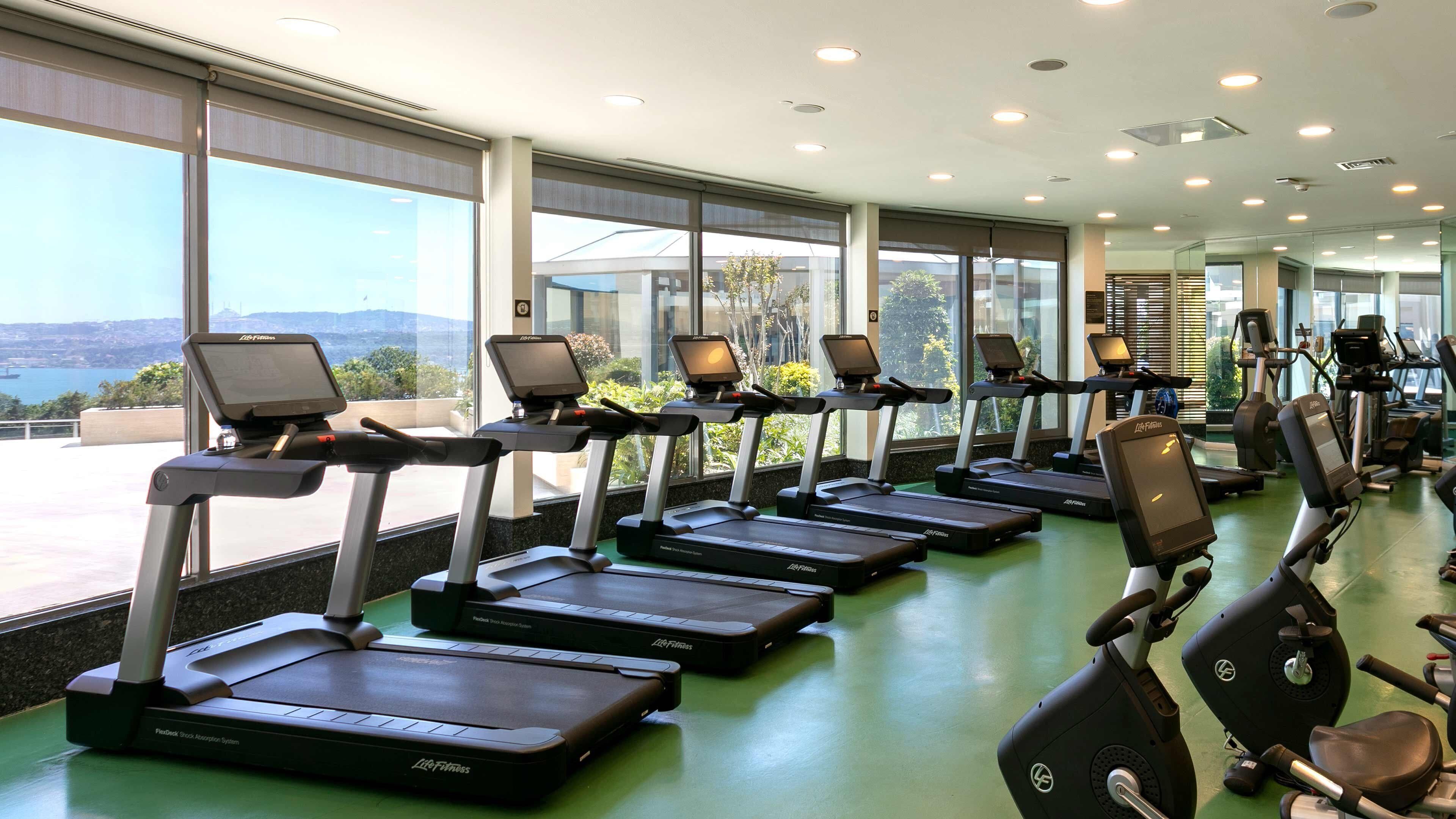 A gym with treadmills, weight machines, and exercise equipment.