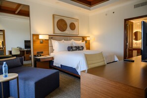 A hotel room with a bed, bedside tables, a desk, a chair, a water bottle, and a TV. - Real InterContinental Managua at Metrocentro Mall by IHG (Managua)