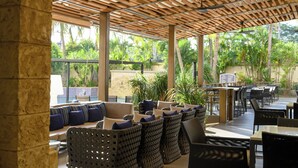 An outdoor seating area with wicker furniture and a wooden ceiling. - Real InterContinental Managua at Metrocentro Mall by IHG (Managua)