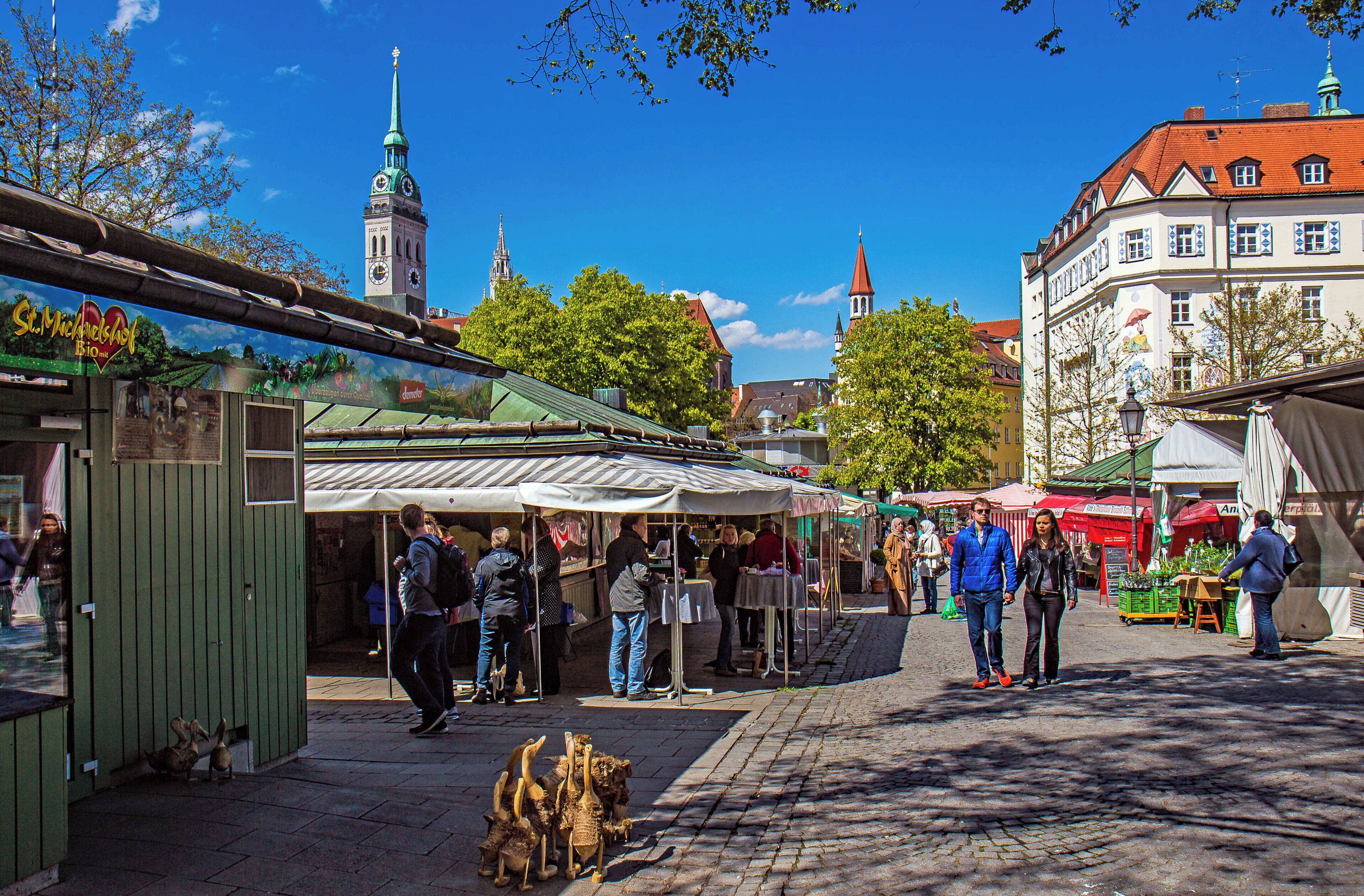 A bustling outdoor market with stalls and people.