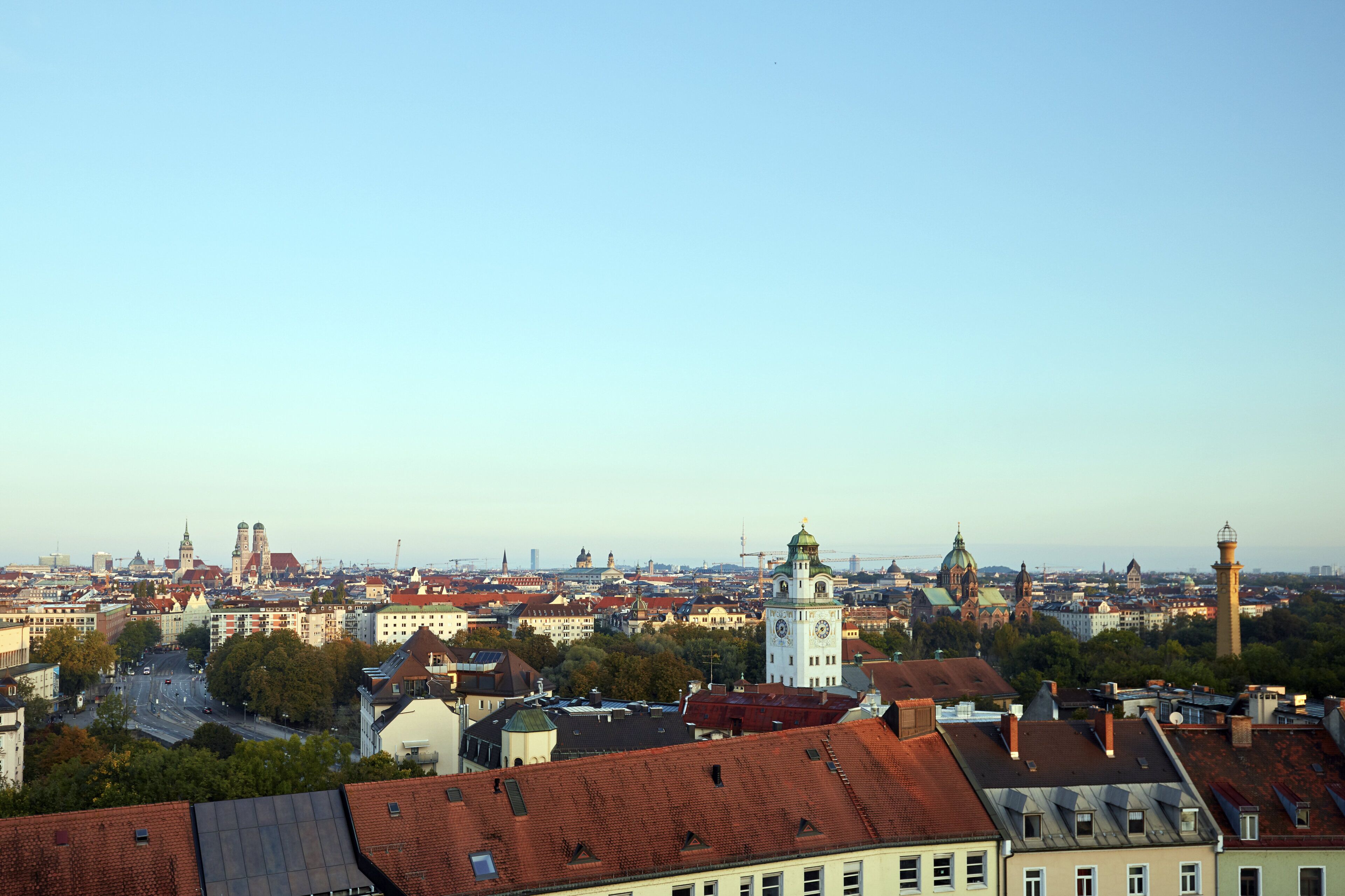 A cityscape with historic buildings, a prominent clock tower, and a mix of residential and commercial structures.