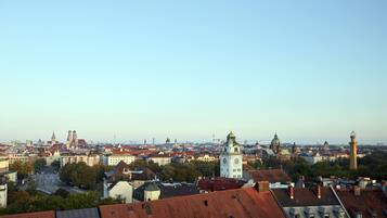 A cityscape with historic buildings, a prominent clock tower, and a mix of residential and commercial structures.