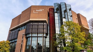 A building with a prominent 'Gasteig' sign, large windows, and a modern architectural design.