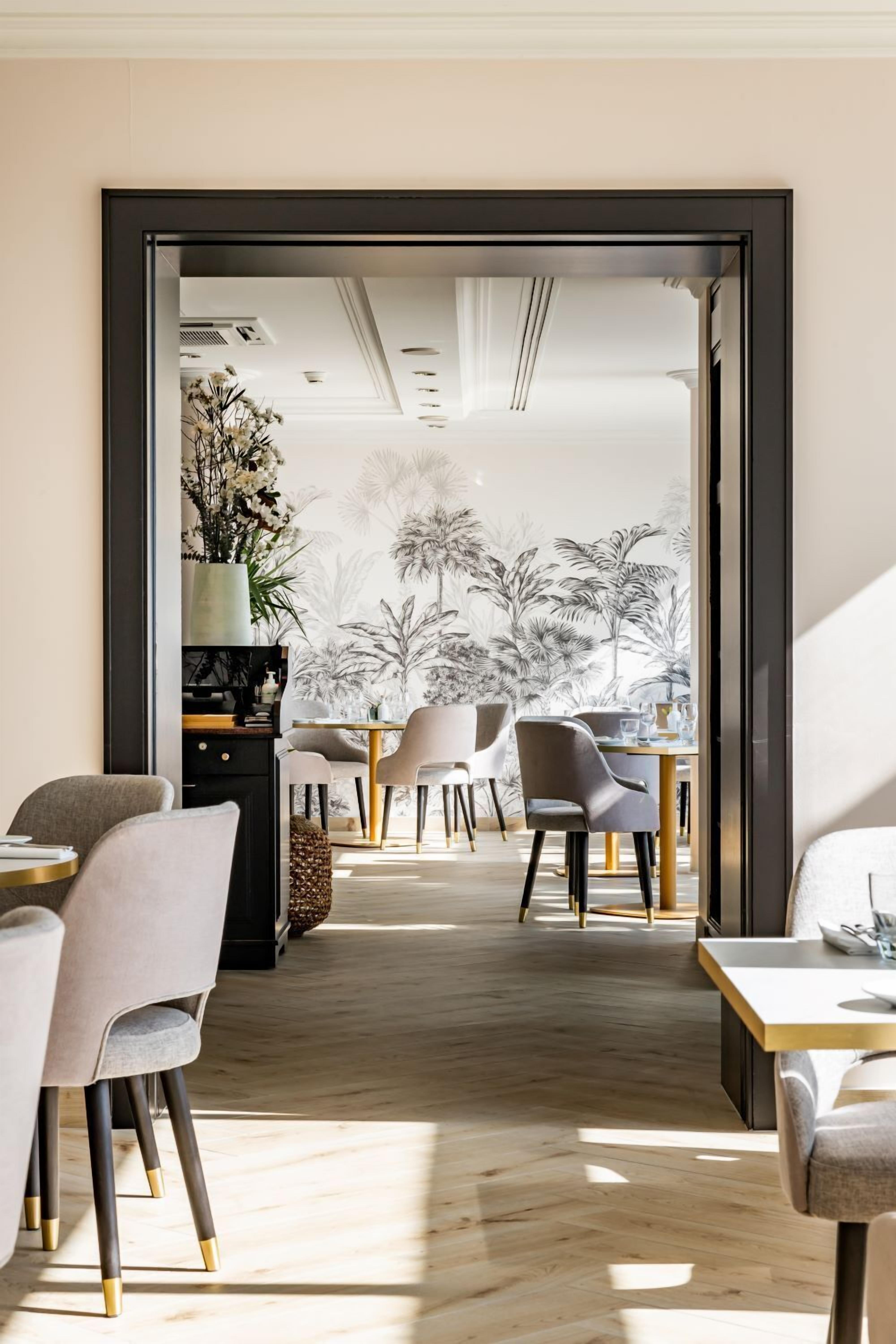 A modern interior with a dining area, chairs, and a table.