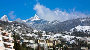 Un pueblo con montañas nevadas al fondo, que presenta una combinación de edificios residenciales y comerciales.