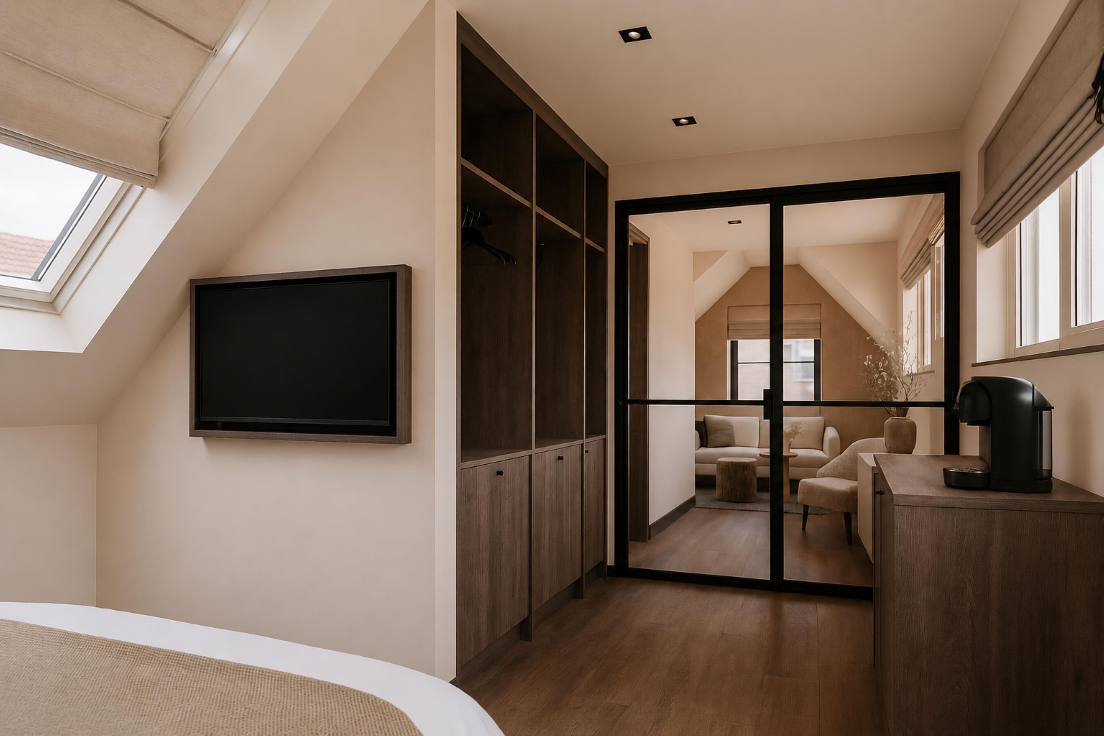 A modern bedroom with a large bed, a wardrobe, a TV, and a coffee machine.