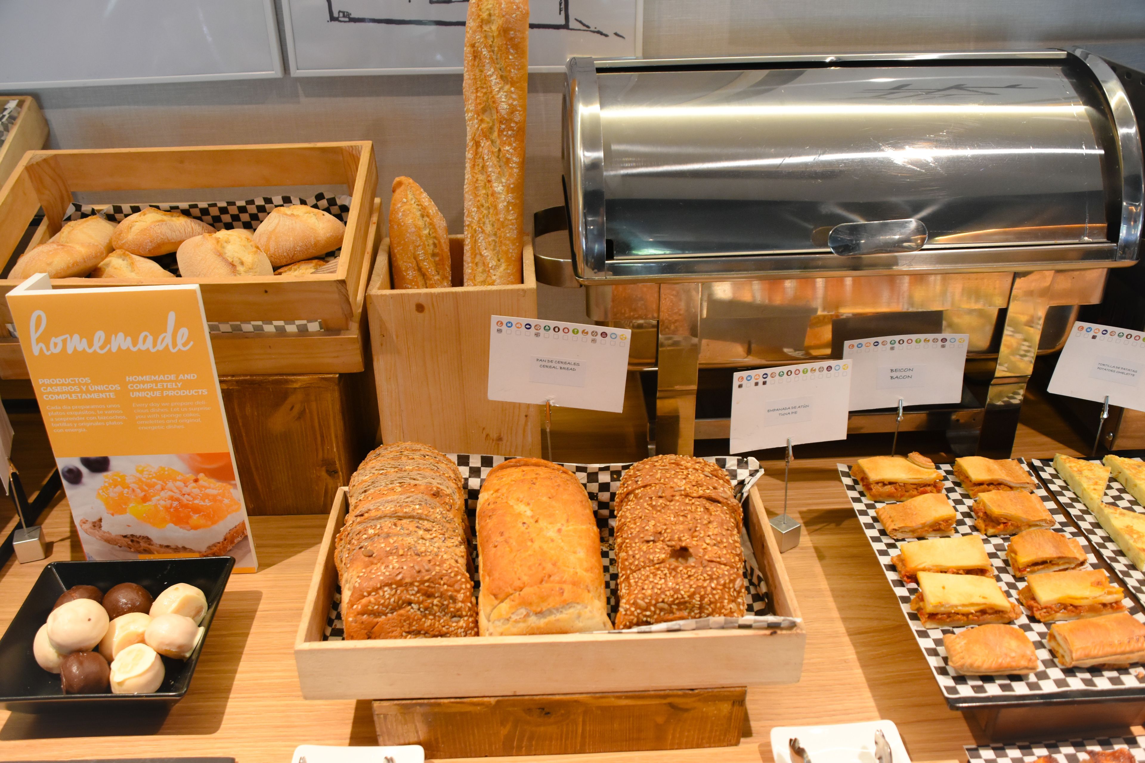 A bakery display with various breads and pastries.