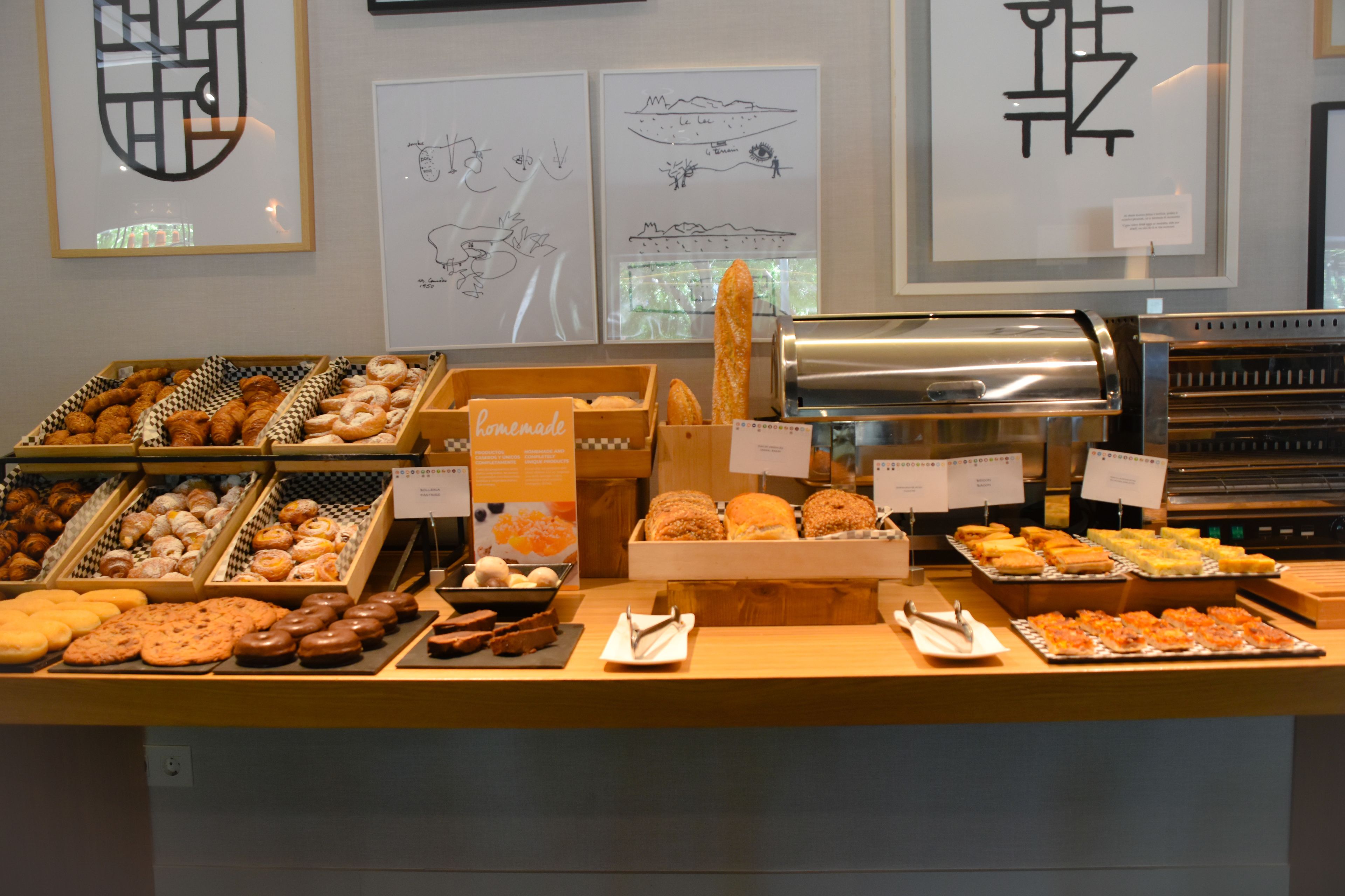 A bakery display with various baked goods and a coffee machine.