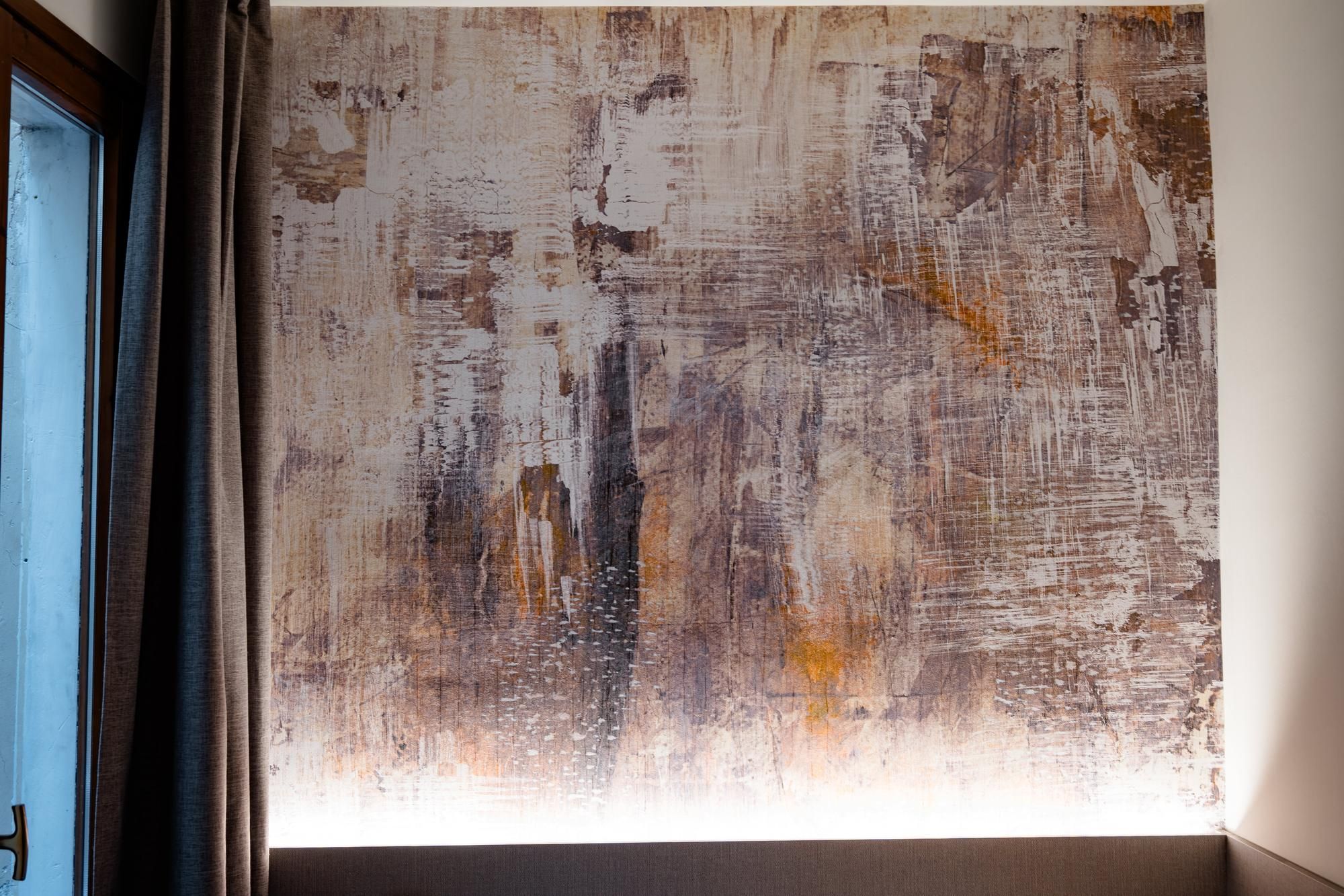 A textured wall with a rough, distressed finish.