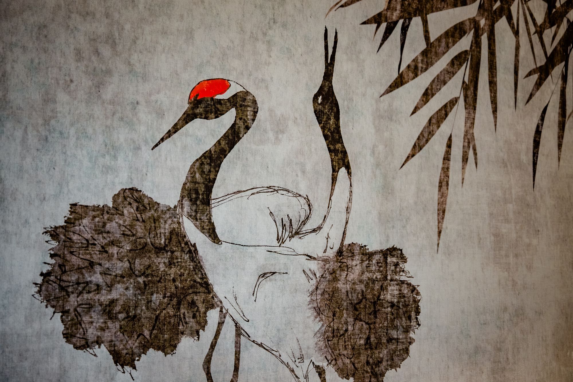 A traditional painting of a bird with a red head and a long neck, surrounded by foliage.