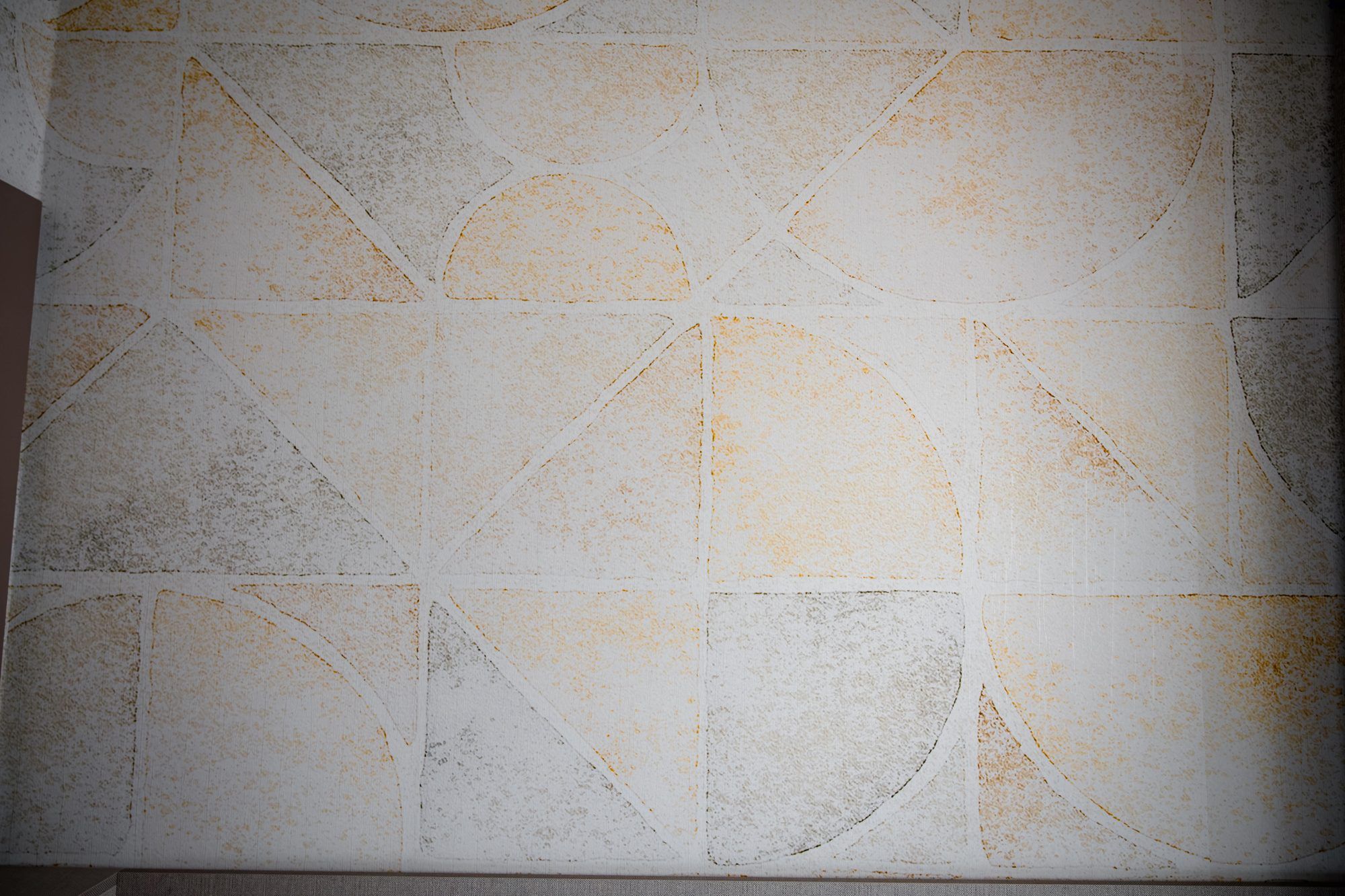 A tiled wall with a geometric pattern.