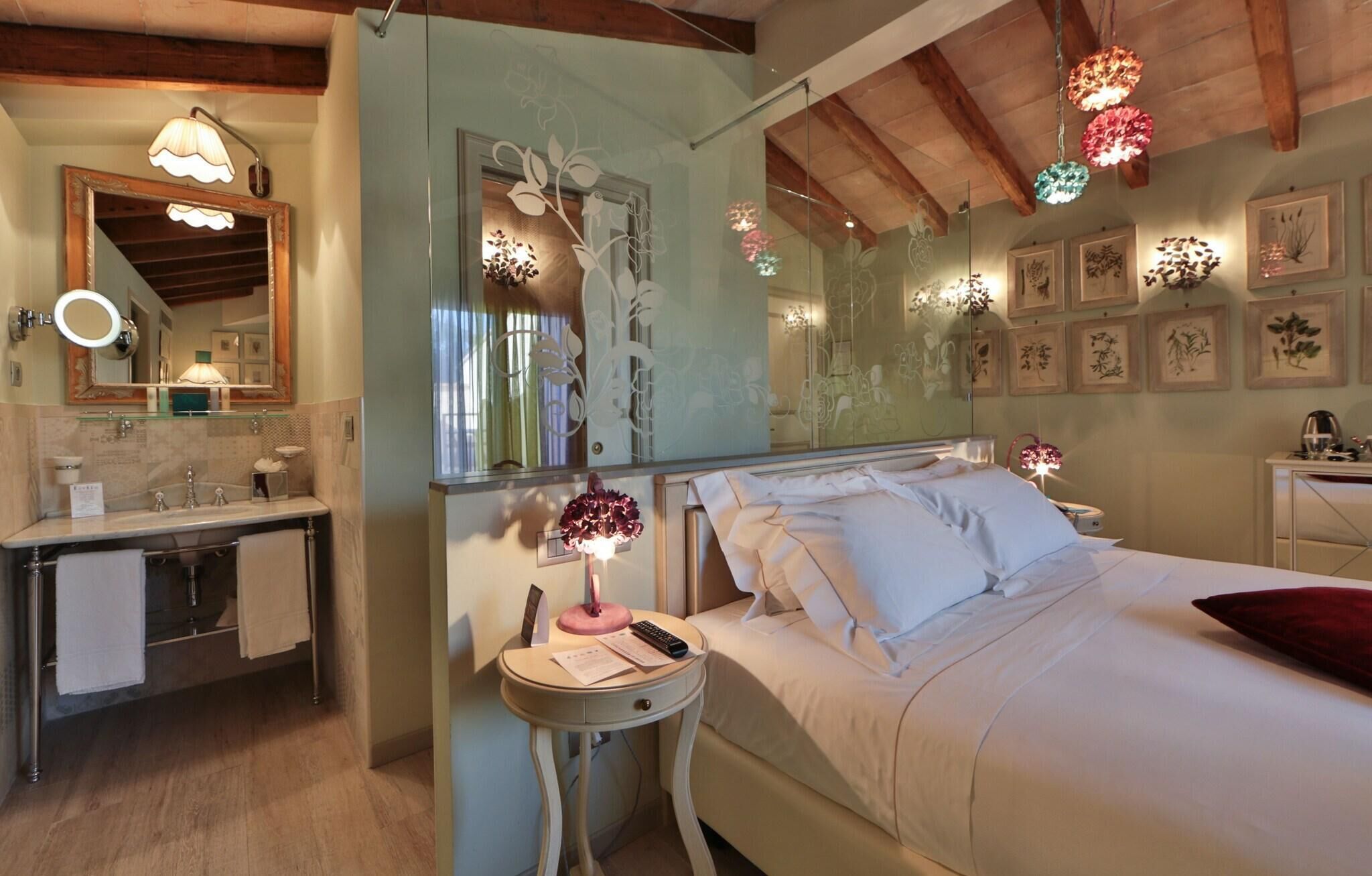 A bedroom with a bed, bedside table, and a mirror.