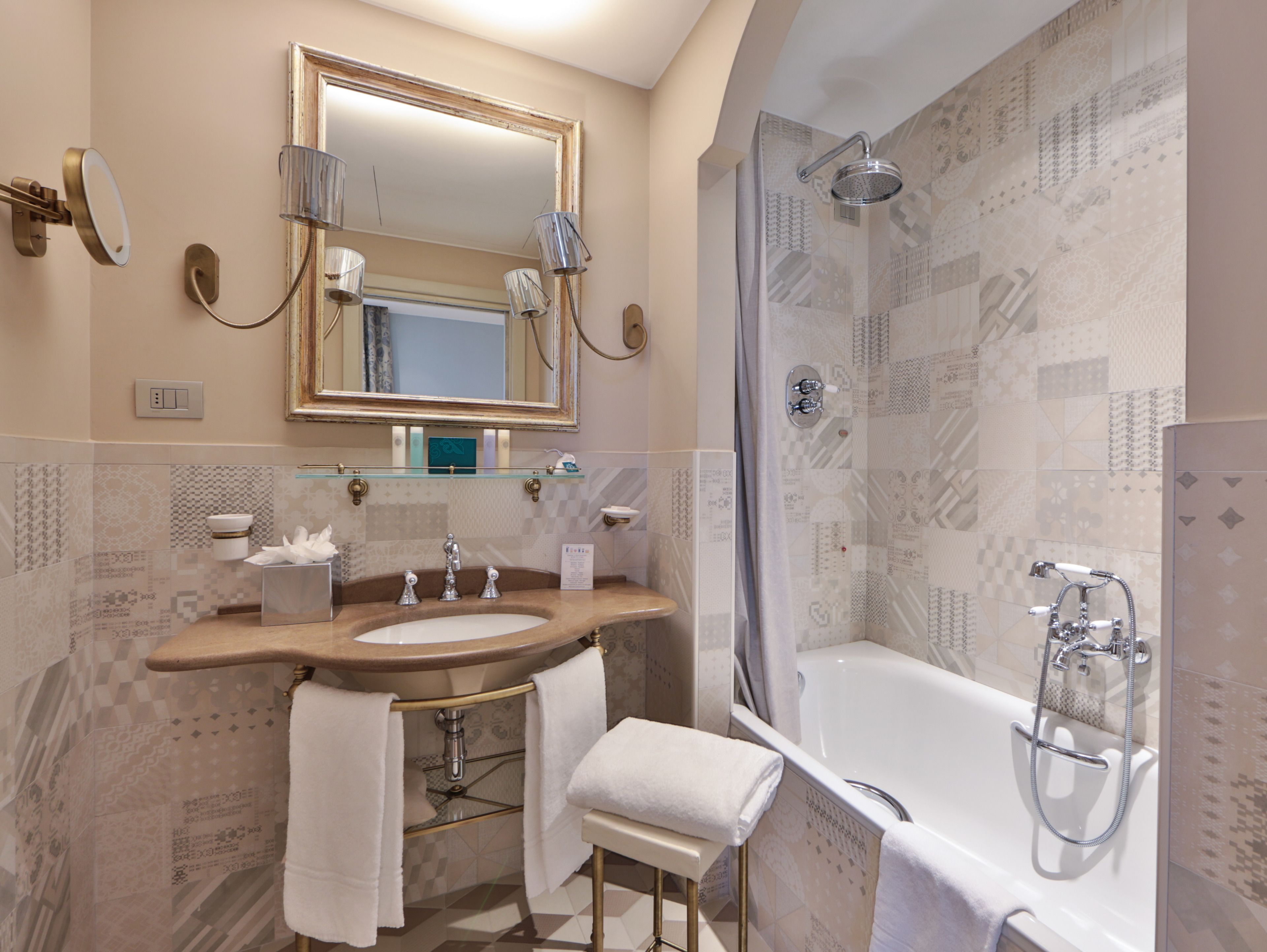 A modern bathroom with a large mirror, a sink, a bathtub, and a shower.