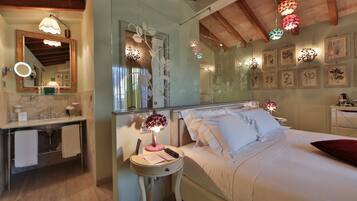 A bedroom with a bed, bedside table, and a mirror.
