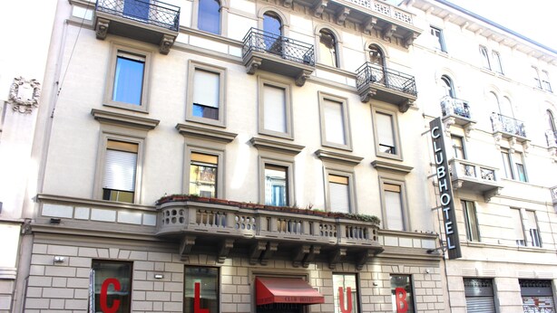 A hotel with a classic facade, multiple balconies, and a prominent 'CLUB HOTEL' sign. - Hotel Club (Milan)