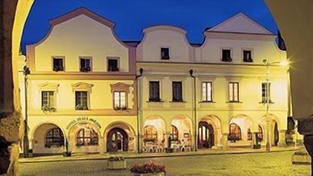 A large, multi-story building with a symmetrical facade, arched windows, and a central entrance. - Hotel Zlata Hvezda Trebon (Trebon)