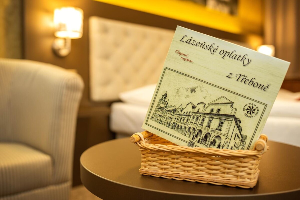 A hotel room with a woven basket holding a welcome card.