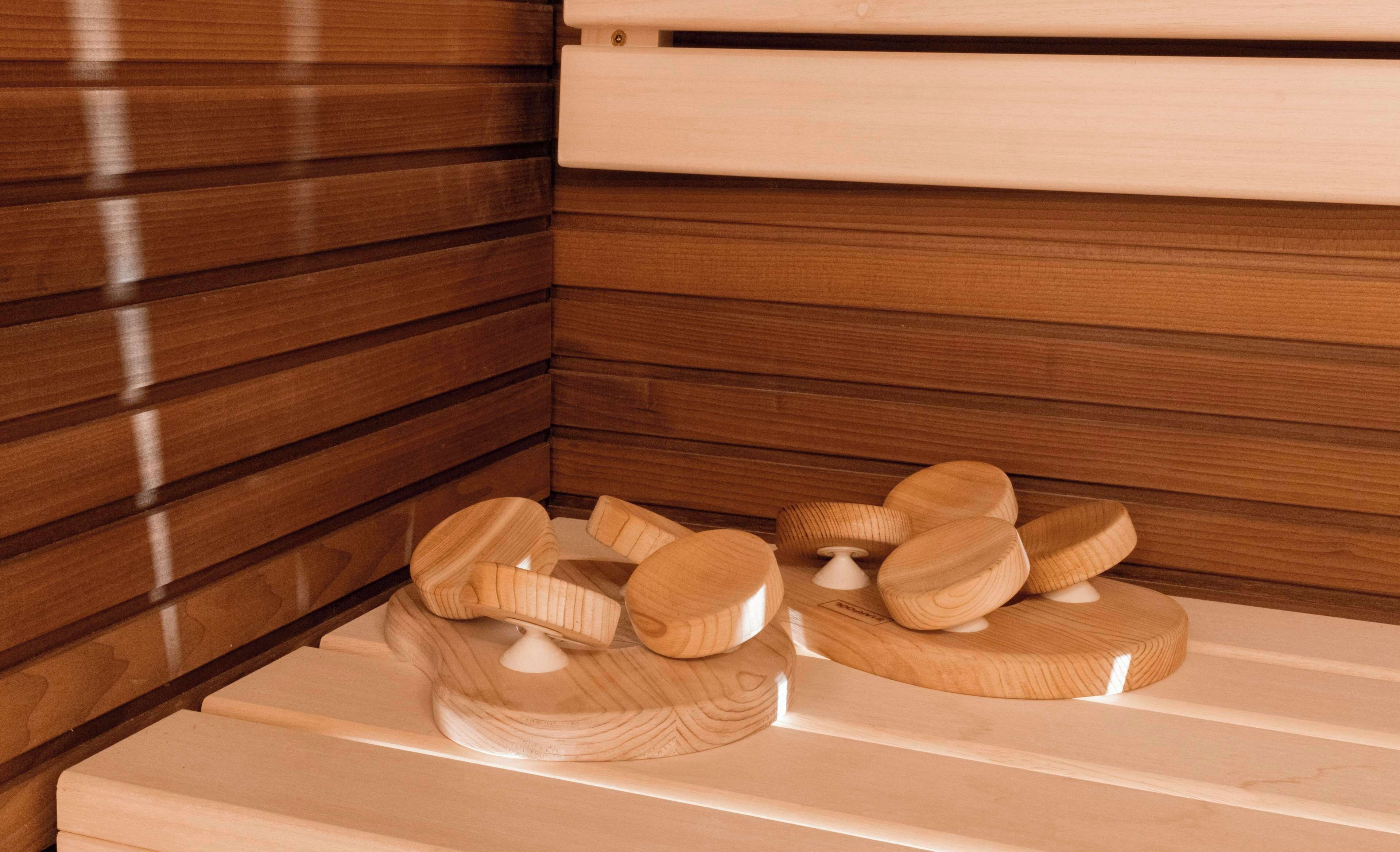 Un banco de madera con un cojín blanco y una escultura de madera.
