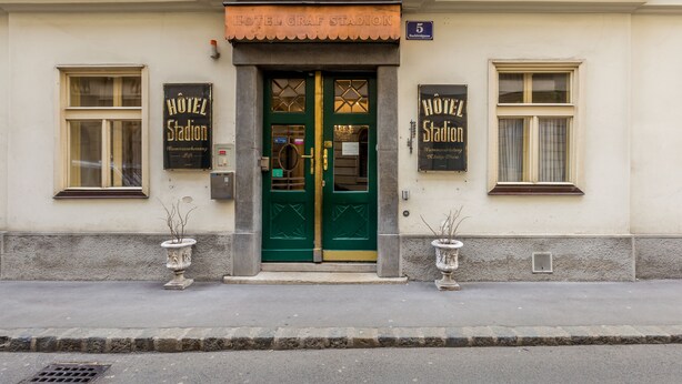 A building with a green door and two signs reading "HOTEL STADION". - Hotel Graf Stadion (Vienna)