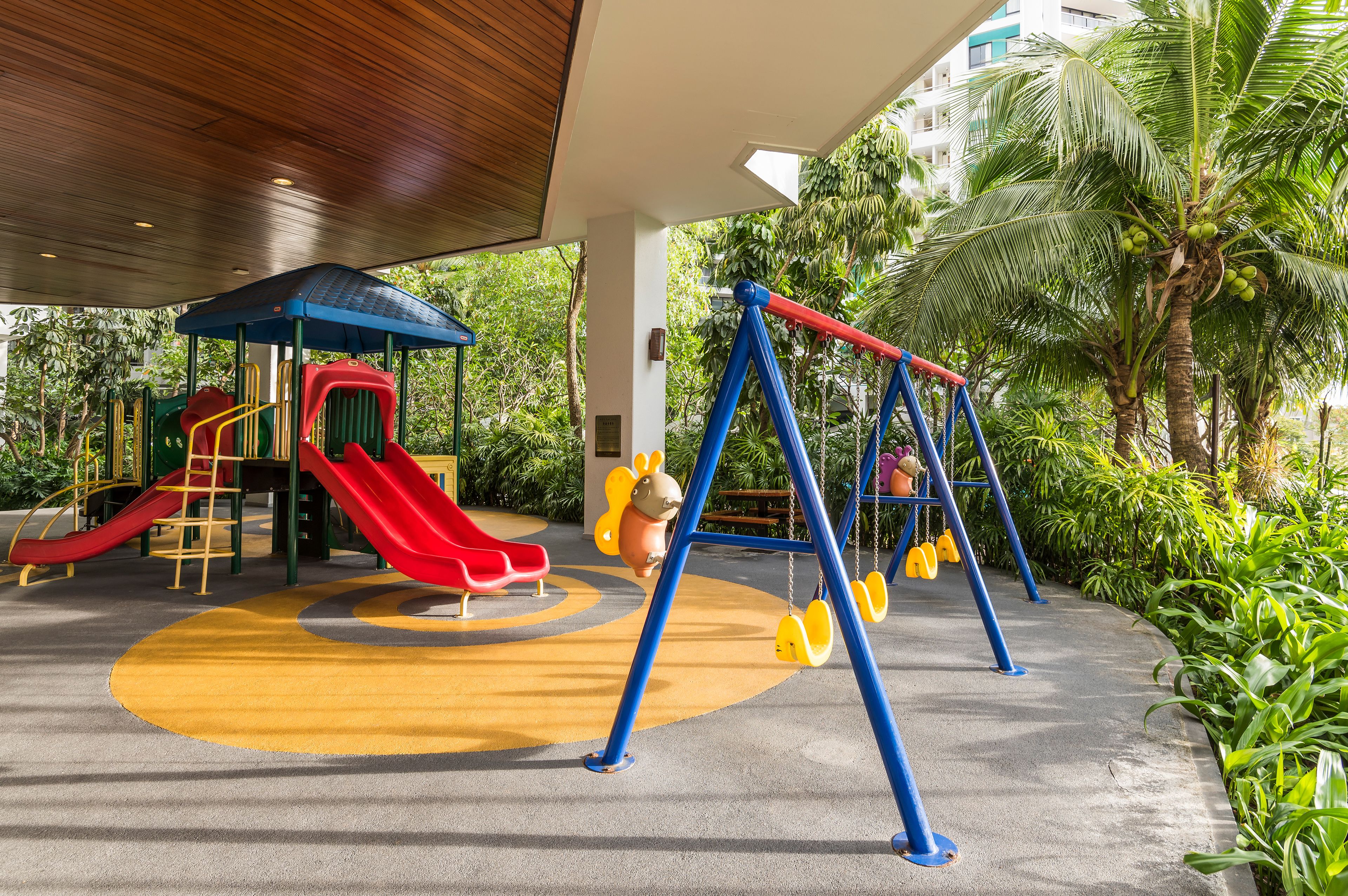 A playground with a slide, swings, and a climbing structure.