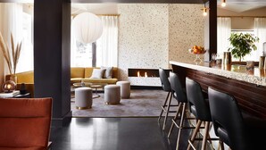 A modern interior with a bar area, seating, and a fireplace. - The Laurel Inn, part of JdV by Hyatt (San Francisco)