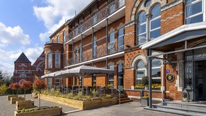 A historic building with a brick facade, large windows, and a balcony with a metal railing. - The Address Cork (Cork)