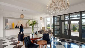A lobby with a checkered floor, a reception desk, and a chandelier. - The Address Cork (Cork)