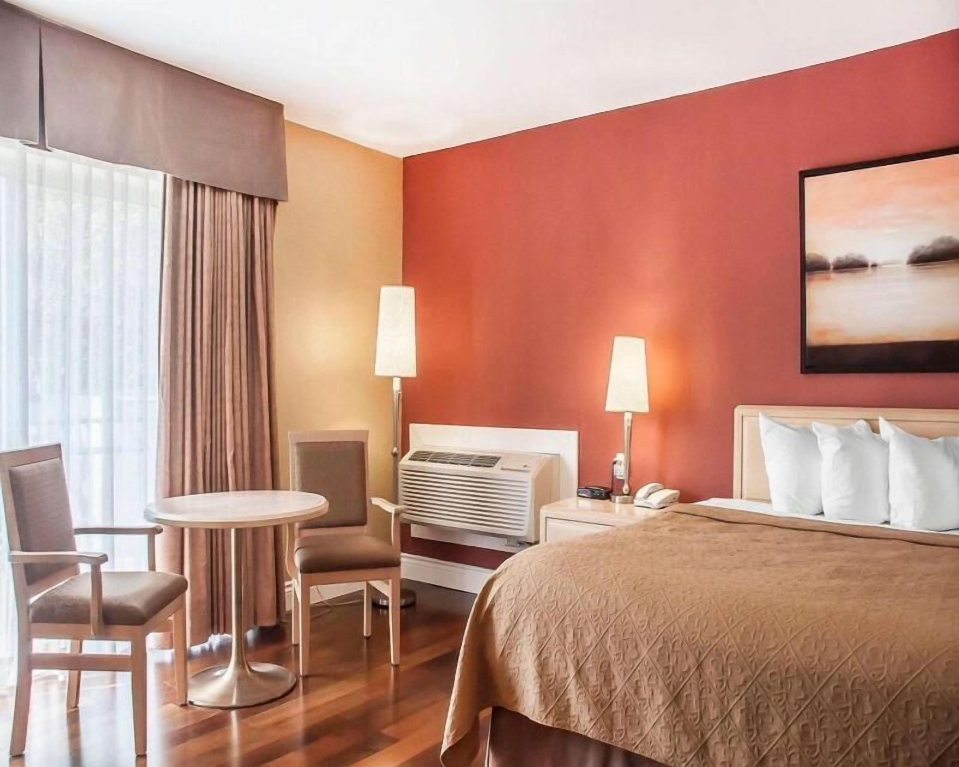 Desk, iron/ironing board, bed sheets, alarm clocks