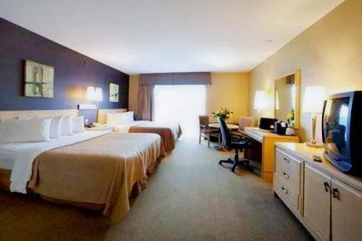 Desk, iron/ironing board, bed sheets, alarm clocks