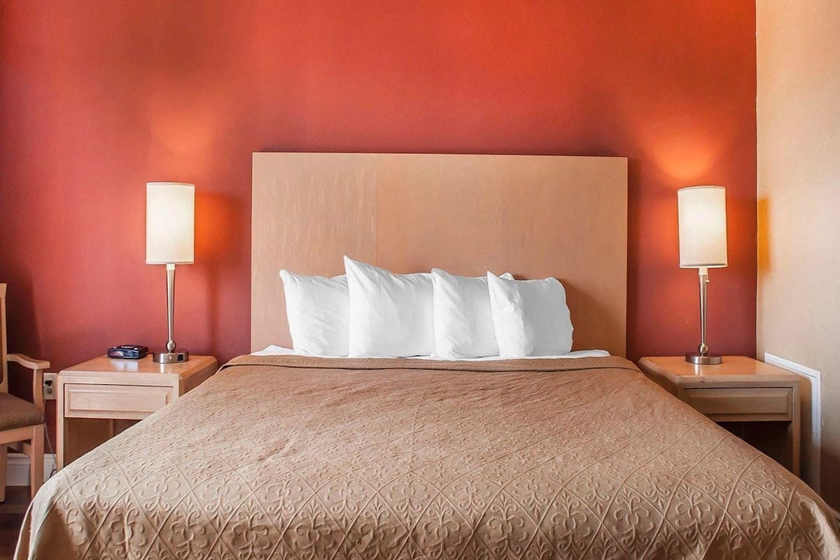 Desk, iron/ironing board, bed sheets, alarm clocks