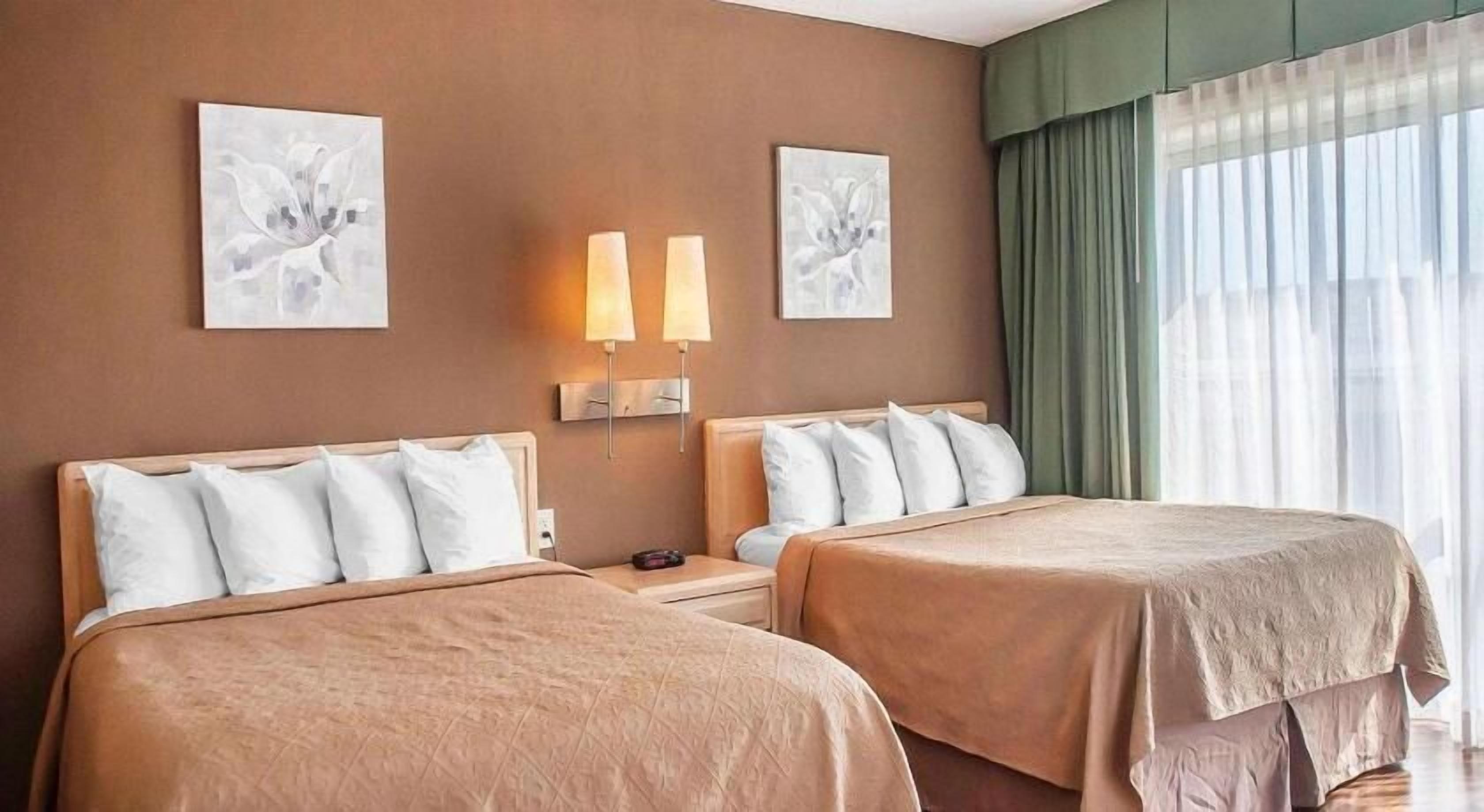 Desk, iron/ironing board, bed sheets, alarm clocks