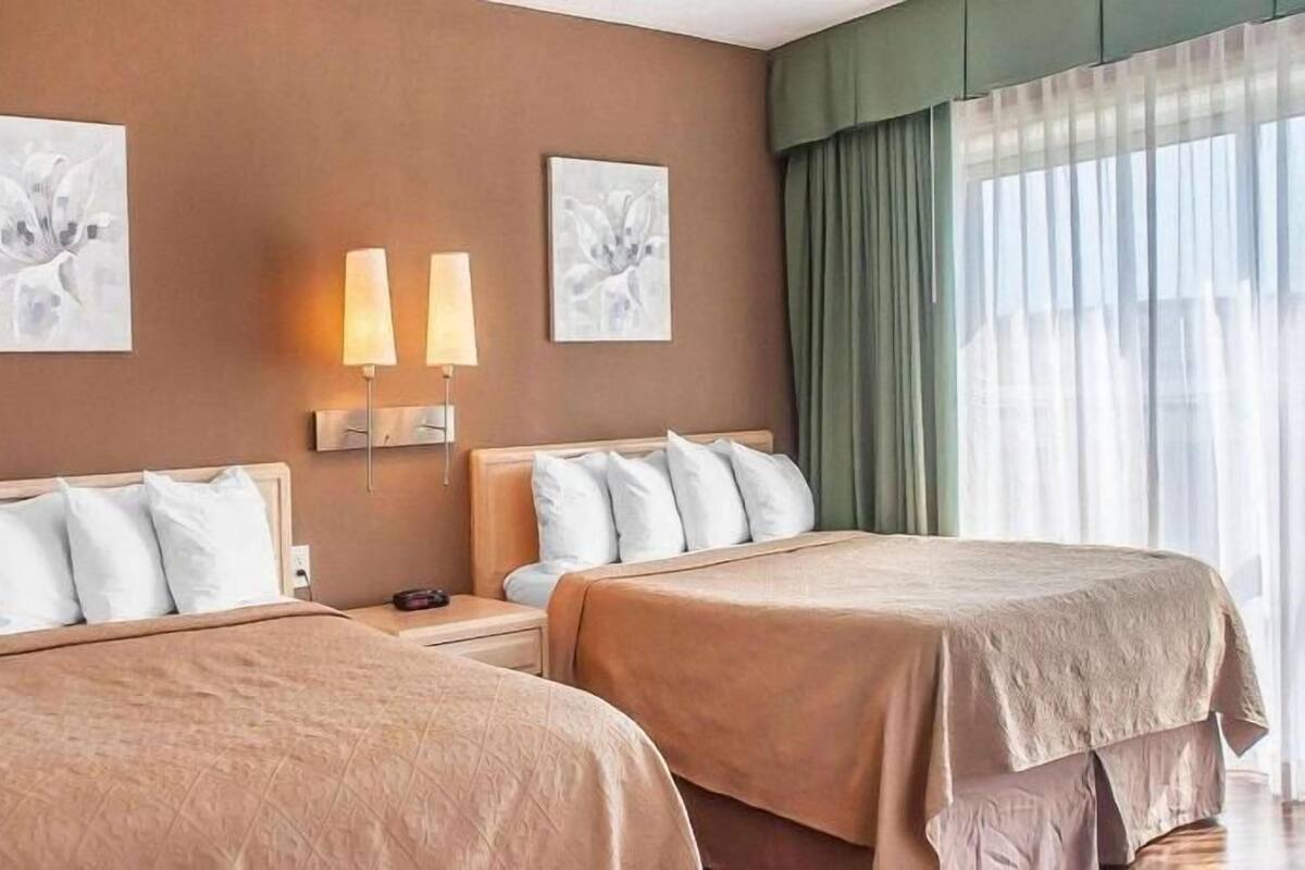 Desk, iron/ironing board, bed sheets, alarm clocks