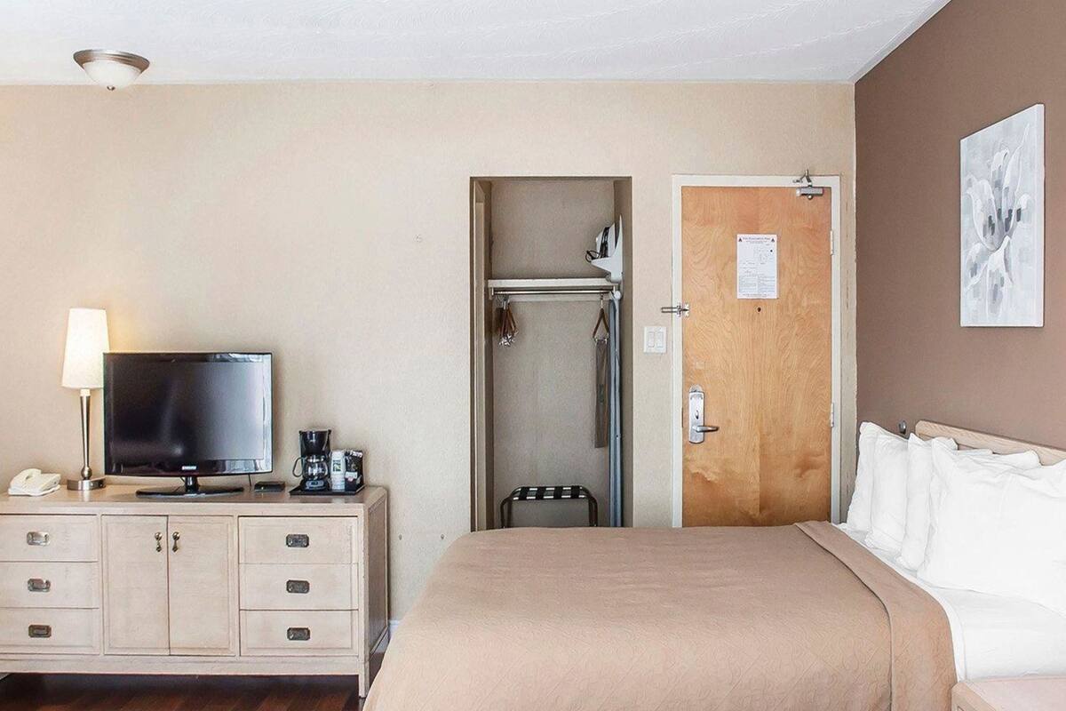 Desk, iron/ironing board, bed sheets, alarm clocks