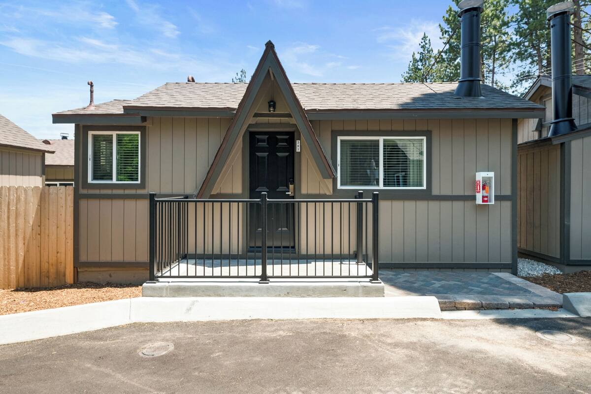 A single-story house with a gabled roof, a front door, and a small porch.
