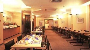 A conference room with long tables and chairs, equipped with nameplates and documents. - Hotel Europacity (Brussels)
