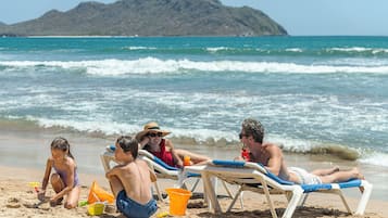 On the beach, sun loungers, beach umbrellas, beach towels