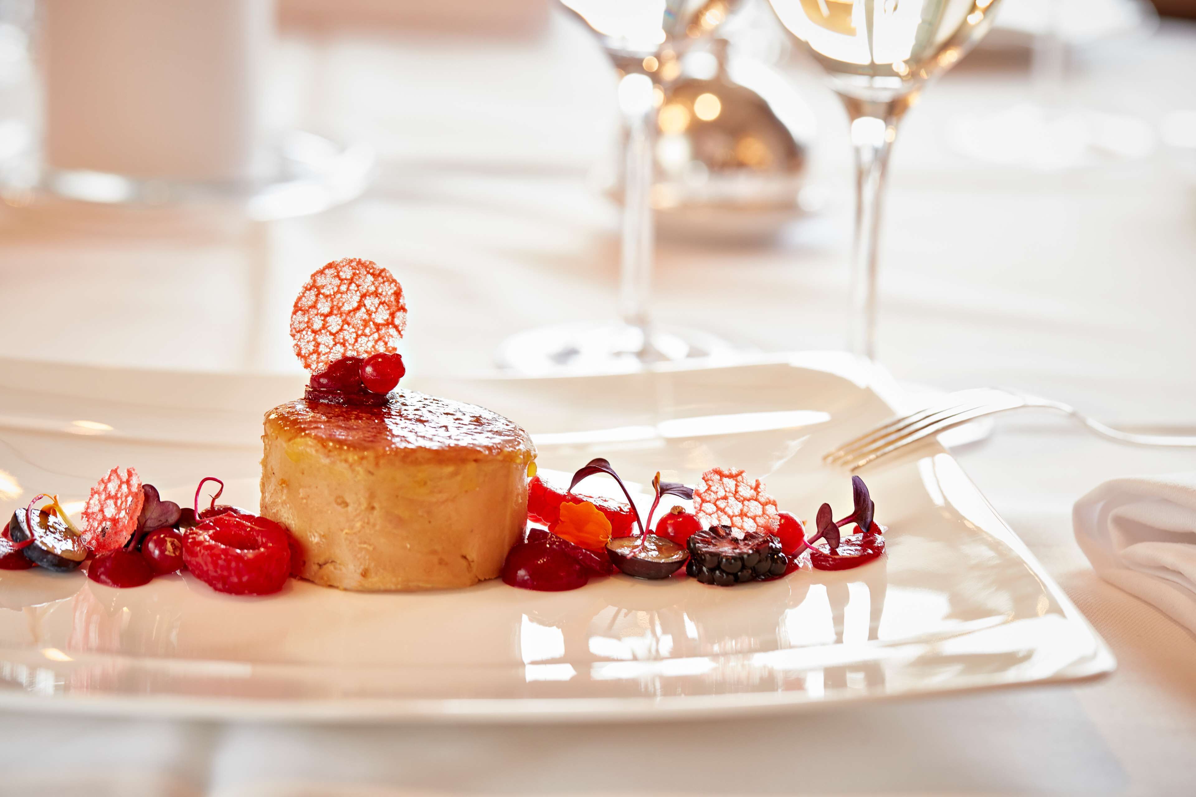 A dessert on a white plate with a fork beside it.