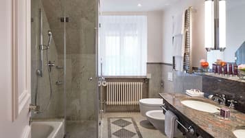 A modern bathroom with a shower, toilet, and sink.