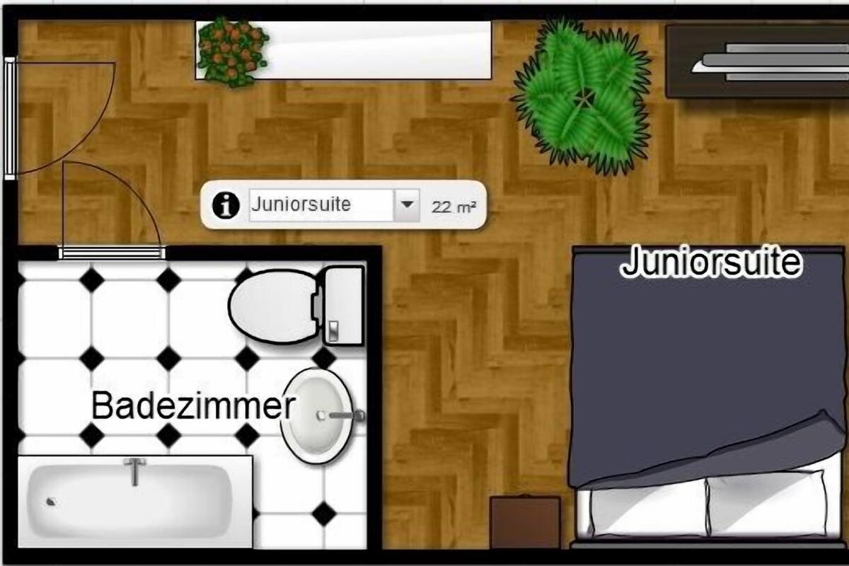 Grundriss eines Zimmers mit Bad, einer Junior Suite und einem Balkon.