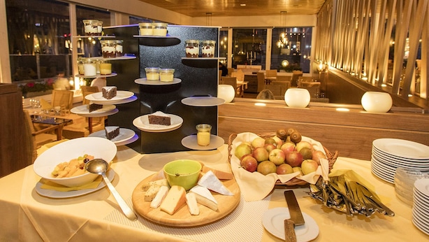 A buffet setup with various food items and a dessert display.