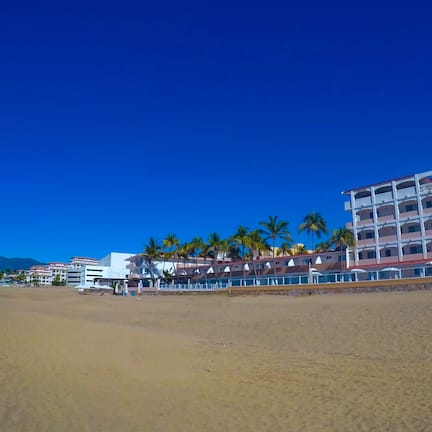On the beach, white sand, beach umbrellas, beach towels