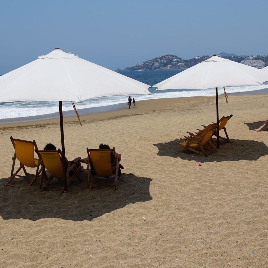 On the beach, white sand, beach umbrellas, beach towels