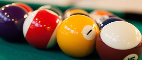 A close-up of billiard balls on a pool table.