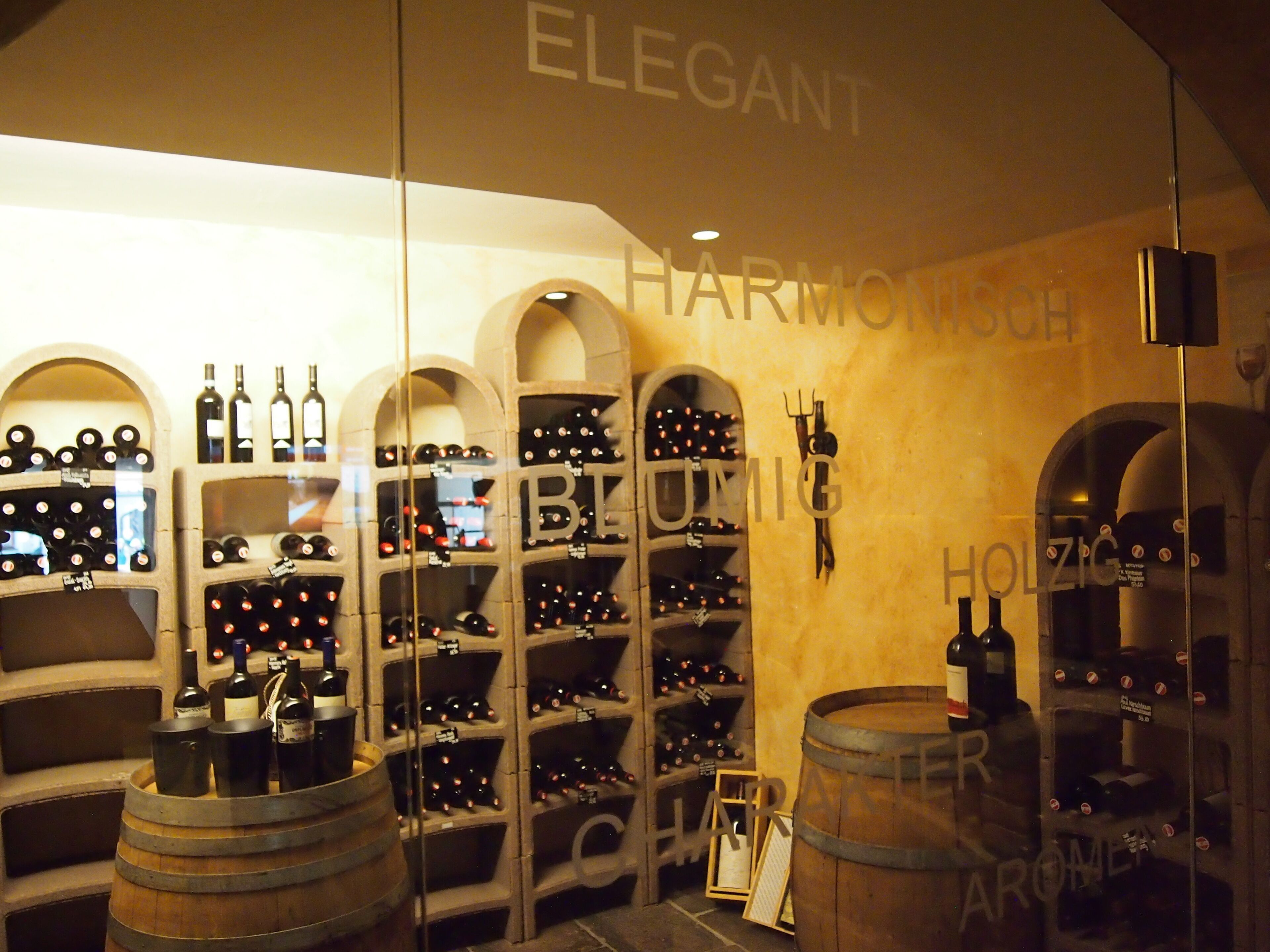 A wine cellar with multiple wine racks and barrels.
