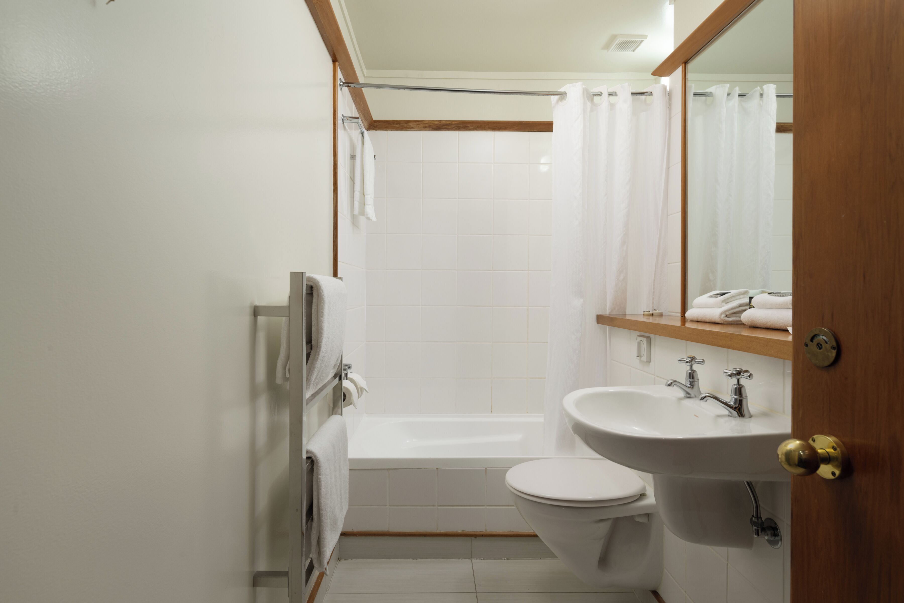 A compact bathroom with a bathtub, toilet, and sink.