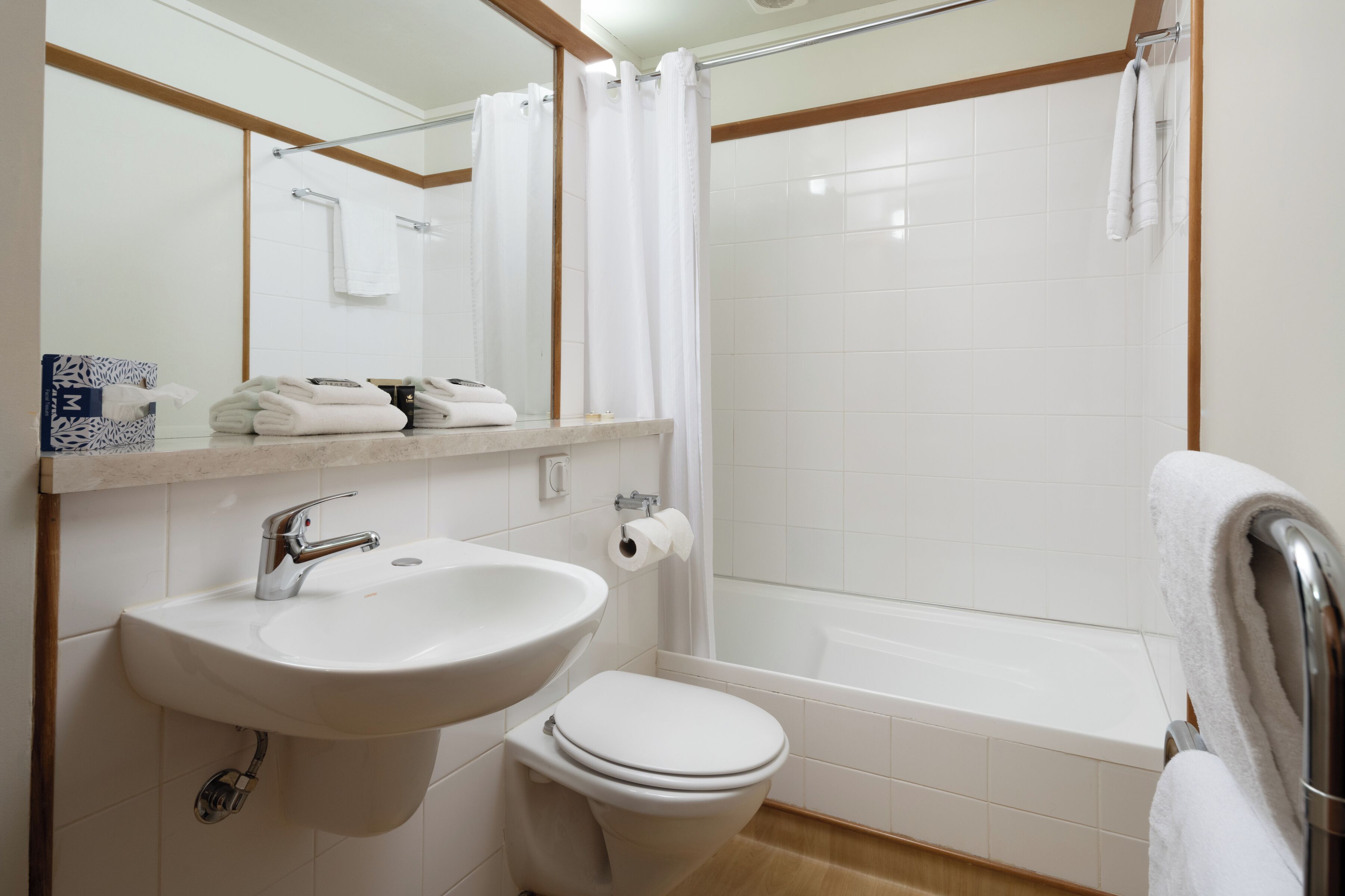 A bathroom with a sink, toilet, and bathtub.