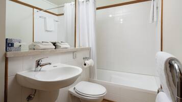 A bathroom with a sink, toilet, and bathtub.
