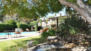 A pool area with lounge chairs and a small waterfall feature. - Carmel Valley Lodge and Resort (Carmel Valley)