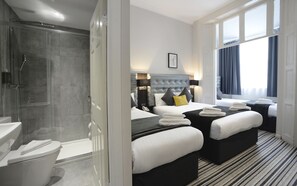 A modern hotel room with a shower, two beds, a large window, and a view of the city. - The 29 London (London)